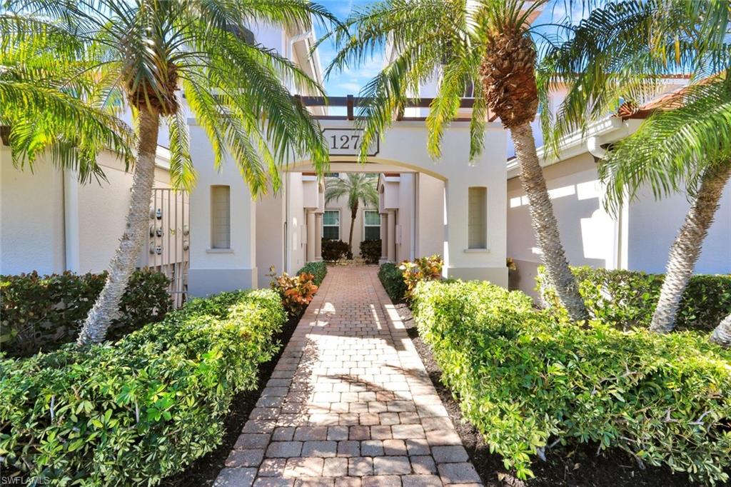 1277 Rialto Way, Unit 201 Naples, FL 34114 - Photo 32 of 46 a front view of a house with a garden