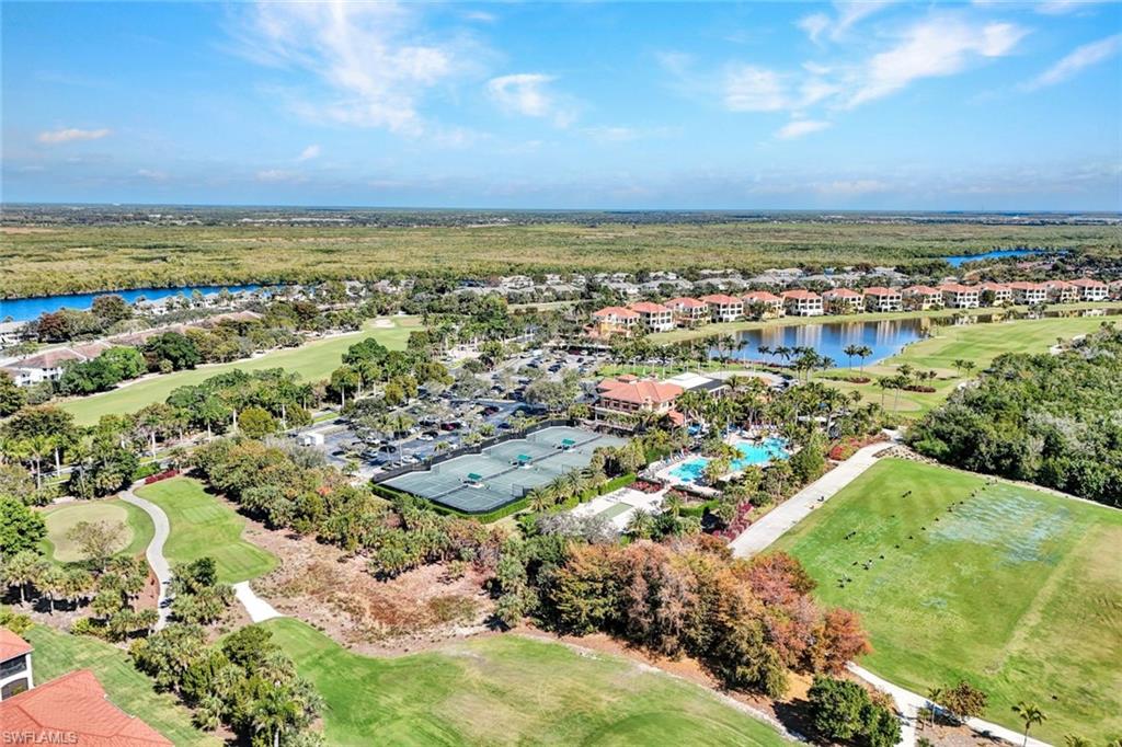 1277 Rialto Way, Unit 201 Naples, FL 34114 - Photo 33 of 46 an aerial view of residential building and lake
