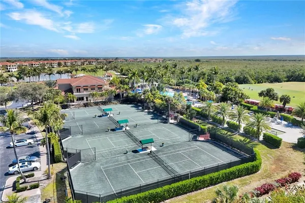 an aerial view of a house with a yard and lake view