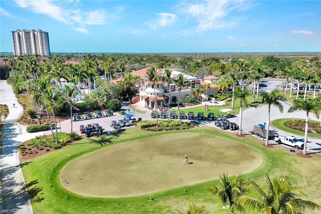 1277 Rialto Way, Unit 201 Naples, FL 34114 - Photo 40 of 46 a view of a swimming pool with an outdoor seating and yard