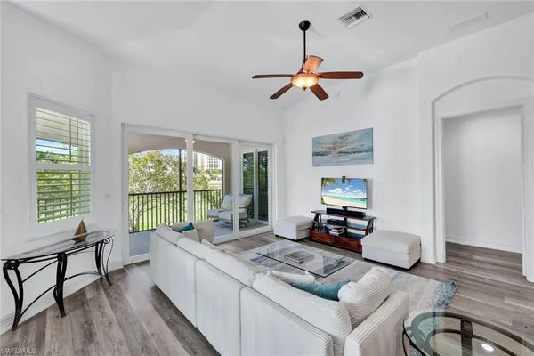 a living room with furniture and a large window