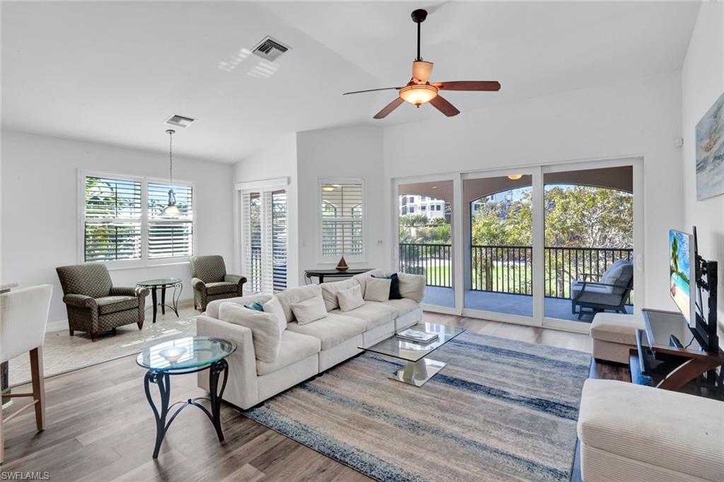 1277 Rialto Way, Unit 201 Naples, FL 34114 - Photo 44 of 46 a living room with furniture and a large window
