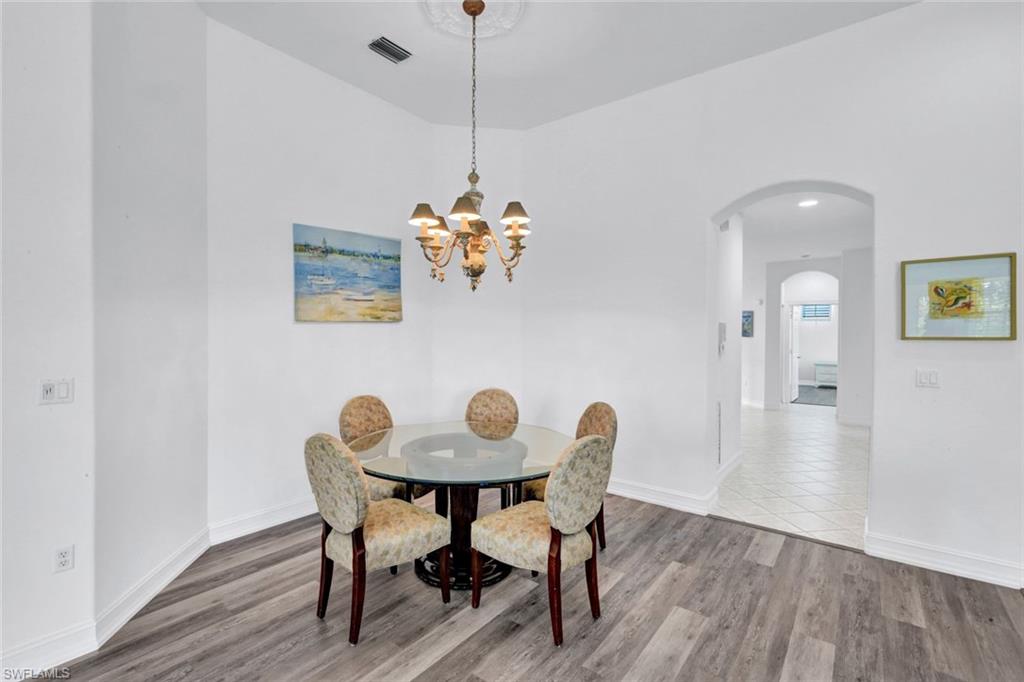 1277 Rialto Way, Unit 201 Naples, FL 34114 - Photo 45 of 46 a view of a dining room with furniture and wooden floor