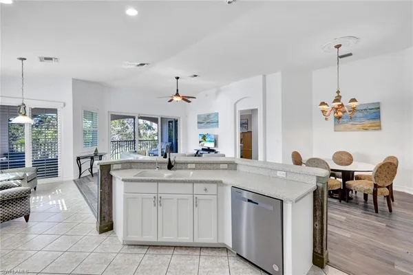 a kitchen with a sink a counter space appliances and cabinets