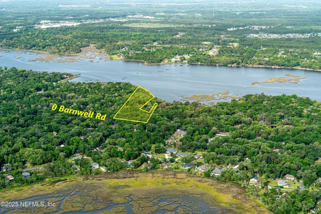an aerial view of a houses with beach
