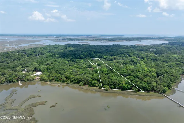 a backyard of a house with a yard and outdoor seating