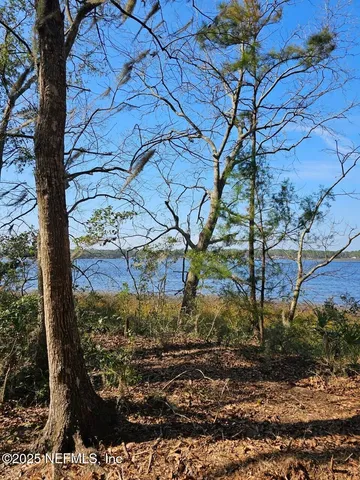 an aerial view of a houses with a yard