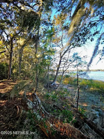 an aerial view of a houses with a yard