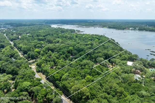 a street sign on a sidewalk next to a road