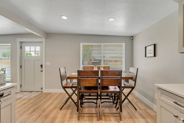 48 Moon Ridge Drive Murray, UT 84107 - Photo 7 of 30 Open concept dining area featuring wood-finish flooring, recessed lighting, and a window with horizontal blinds