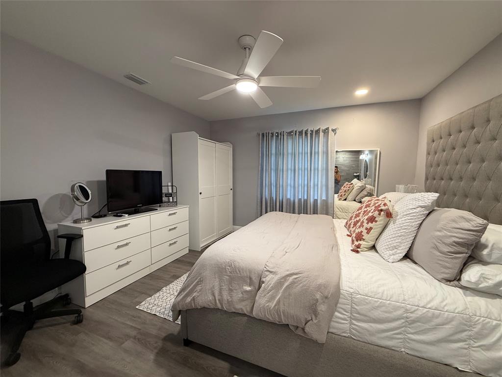 20862 Vinesta Circle Boca Raton, FL 33433 - Photo 12 of 19 a bedroom with a large bed and a flat screen tv