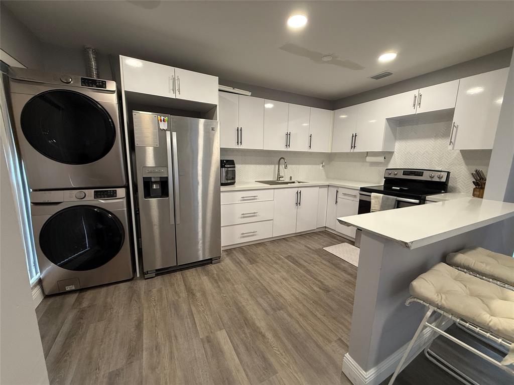 20862 Vinesta Circle Boca Raton, FL 33433 - Photo 3 of 19 a kitchen with a refrigerator a stove top oven a sink and cabinets