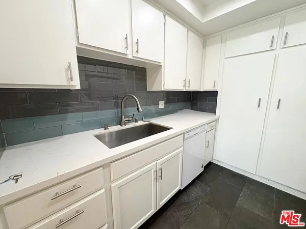 a kitchen with a sink and cabinets
