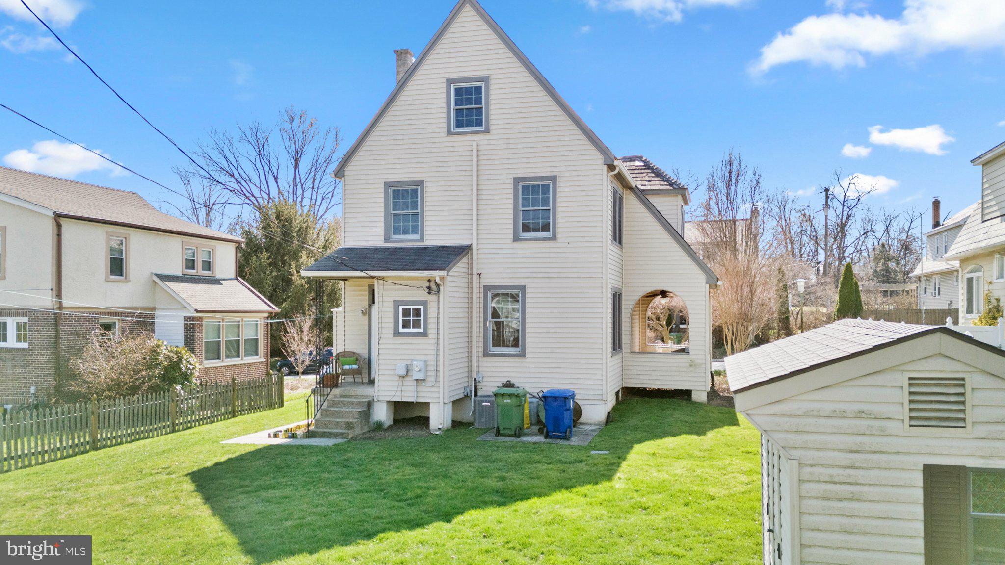 503 Kingston Road Baltimore, MD 21229 - Photo 11 of 15 a view of a white house next to a yard with big trees