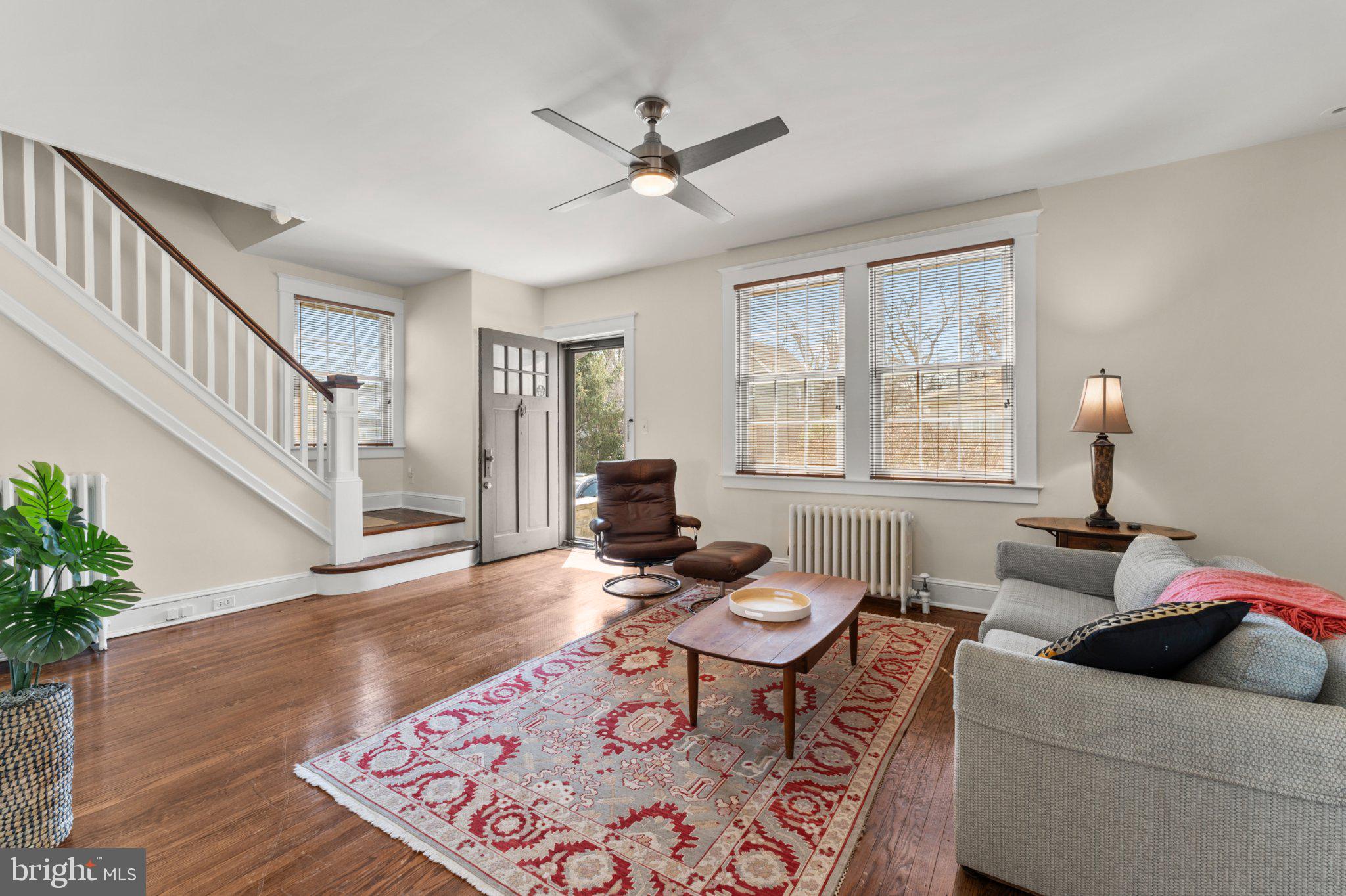 503 Kingston Road Baltimore, MD 21229 - Photo 2 of 15 a living room with furniture floor to ceiling window and a potted plant