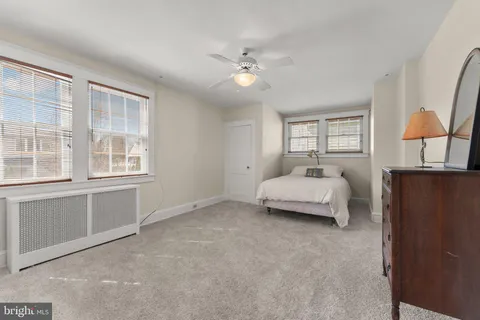 a spacious bedroom with a bed and a cabinets