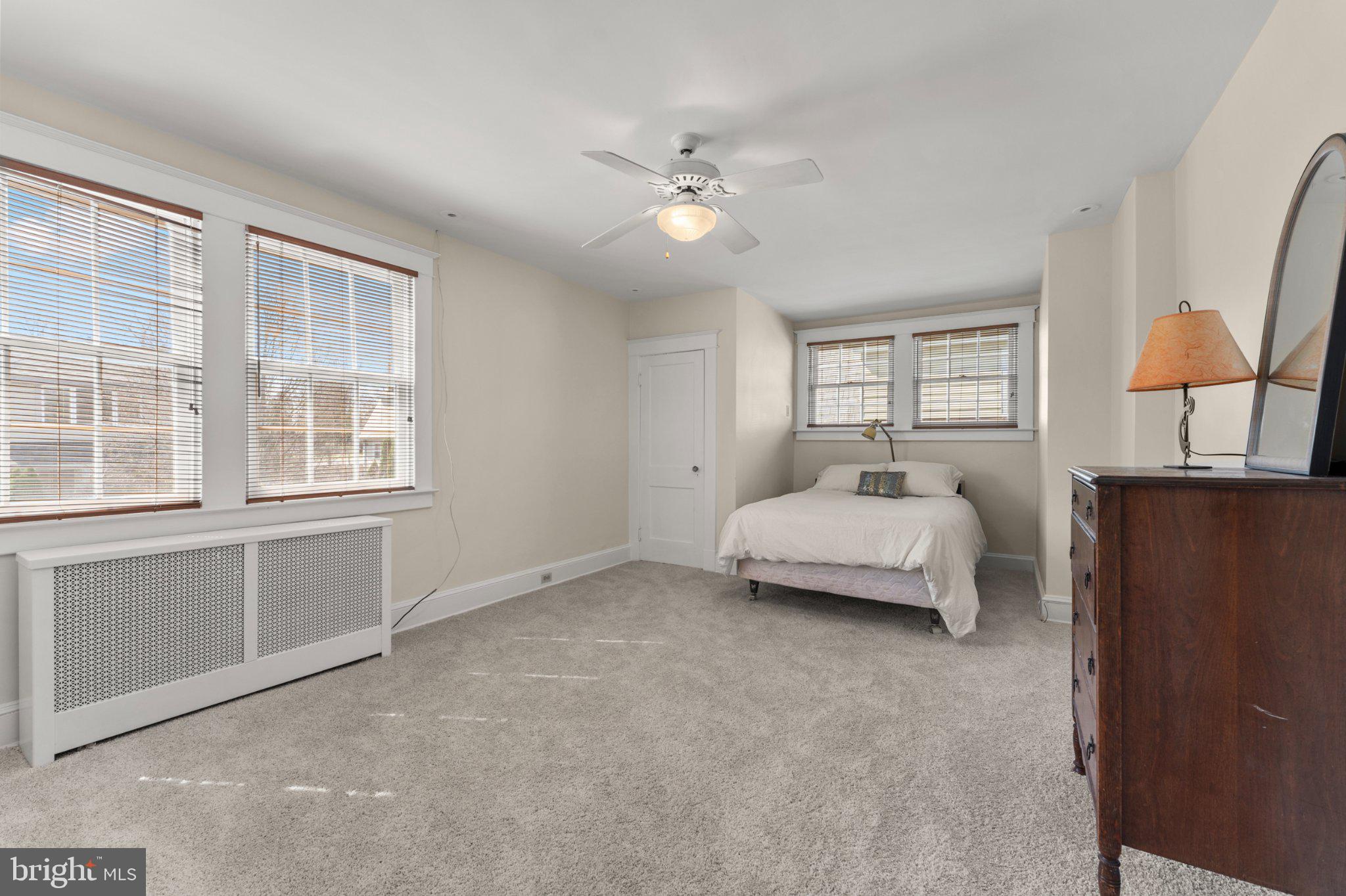 503 Kingston Road Baltimore, MD 21229 - Photo 5 of 15 a spacious bedroom with a bed and a cabinets