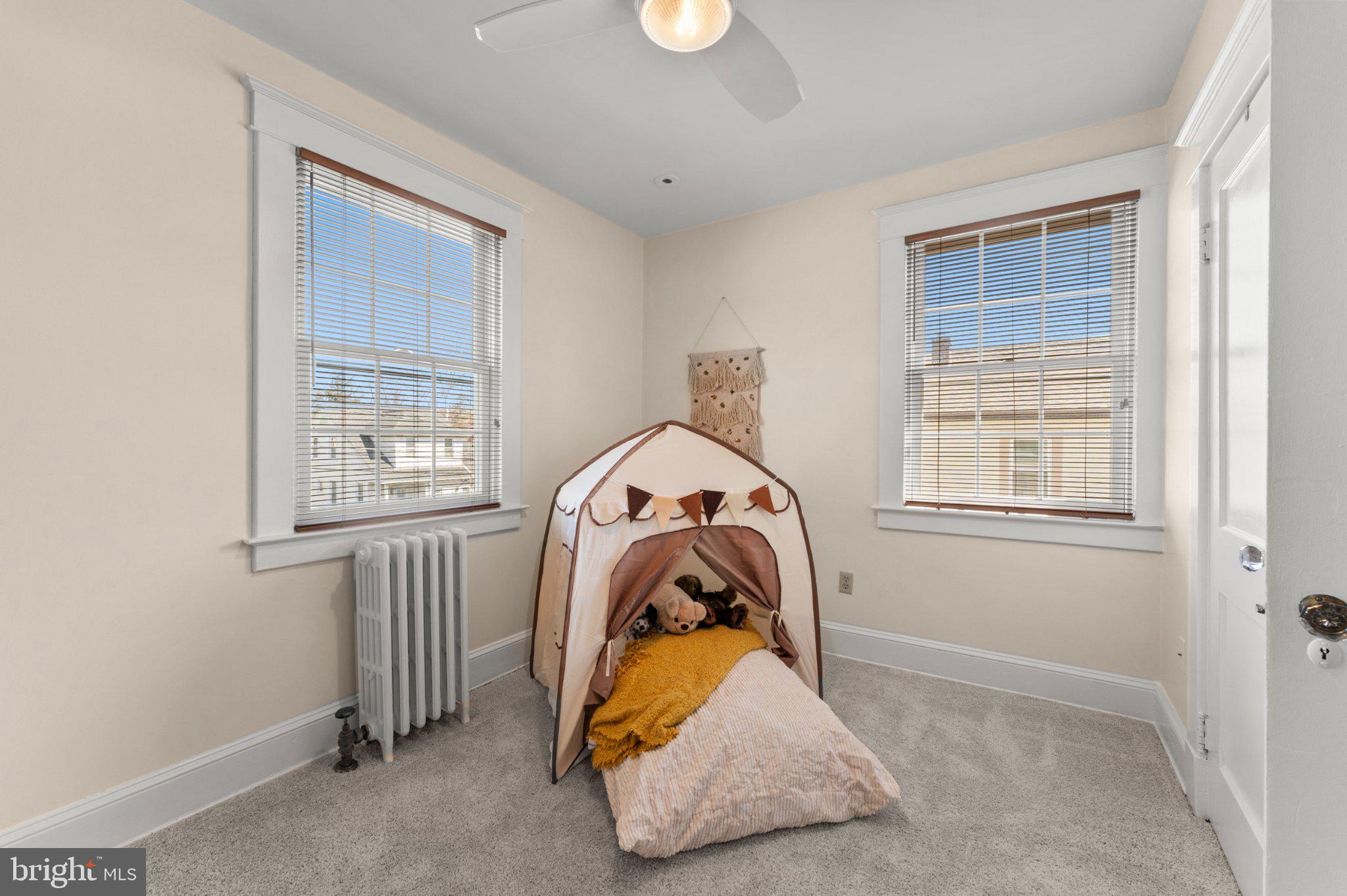 503 Kingston Road Baltimore, MD 21229 - Photo 7 of 15 a view of a livingroom with a window and wooden floor
