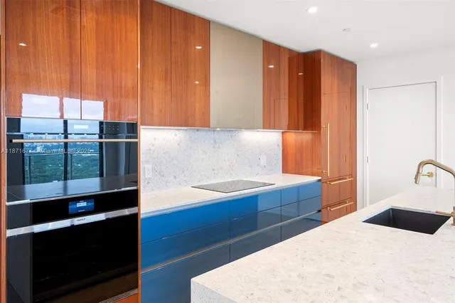 a kitchen with a dining table chairs and cabinets