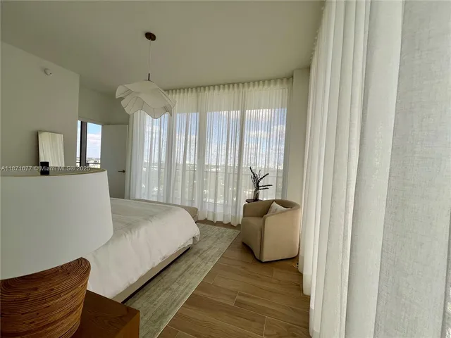 a bathroom with a double vanity sink a mirror and bathtub