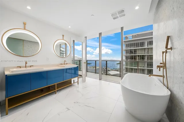 a bathroom with a sink vanity mirror and toilet