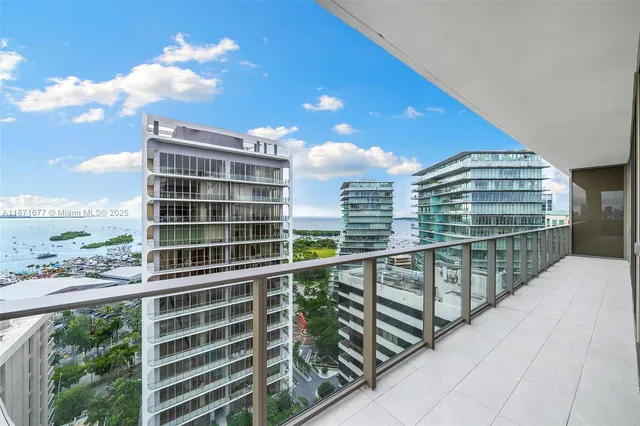 a view of a dining room with furniture and a floor to ceiling window