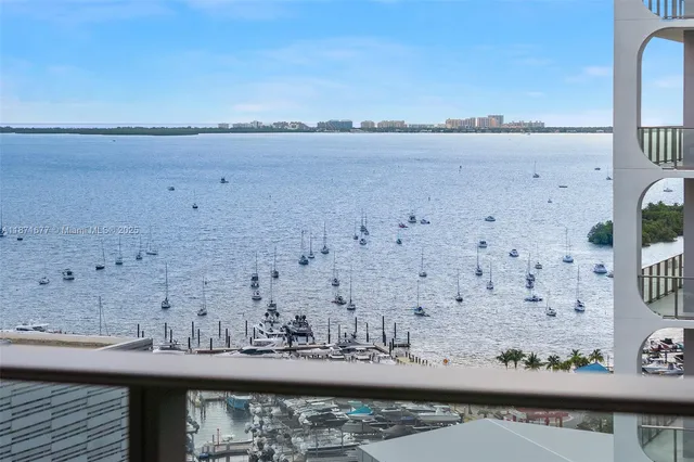 a living room with furniture a table and kitchen view