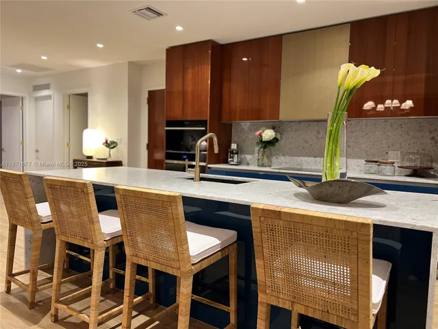 a kitchen with kitchen island granite countertop wooden cabinets and counter space