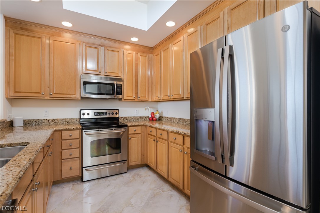 2090 West First Street, Unit J2510 Fort Myers, FL 33901 - Photo 11 of 50 a kitchen with stainless steel appliances granite countertop a refrigerator stove and sink