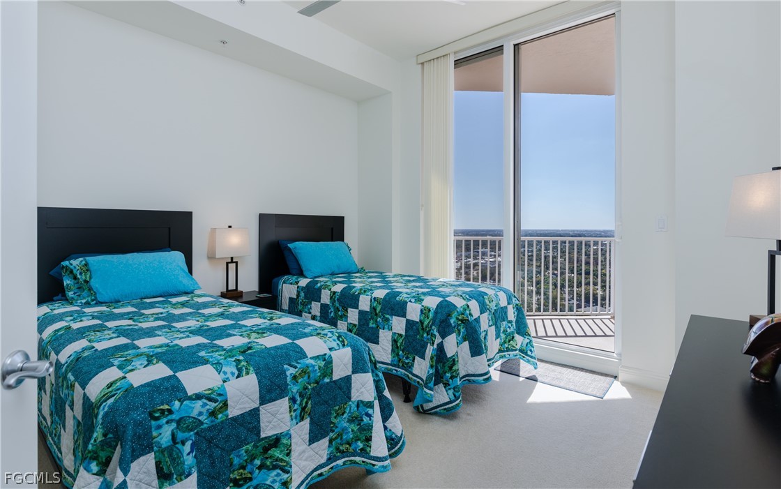 2090 West First Street, Unit J2510 Fort Myers, FL 33901 - Photo 17 of 50 a bedroom with two beds and a lamp