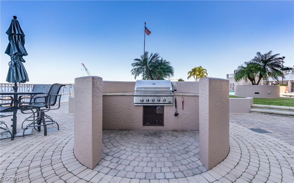 2090 West First Street, Unit J2510 Fort Myers, FL 33901 - Photo 32 of 50 a view of a house with a yard and table