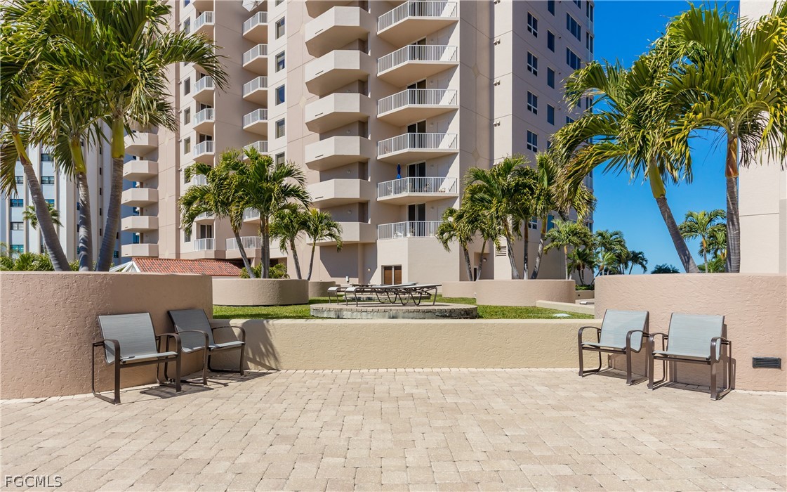 2090 West First Street, Unit J2510 Fort Myers, FL 33901 - Photo 33 of 50 a view of a swimming pool with a lounge chair