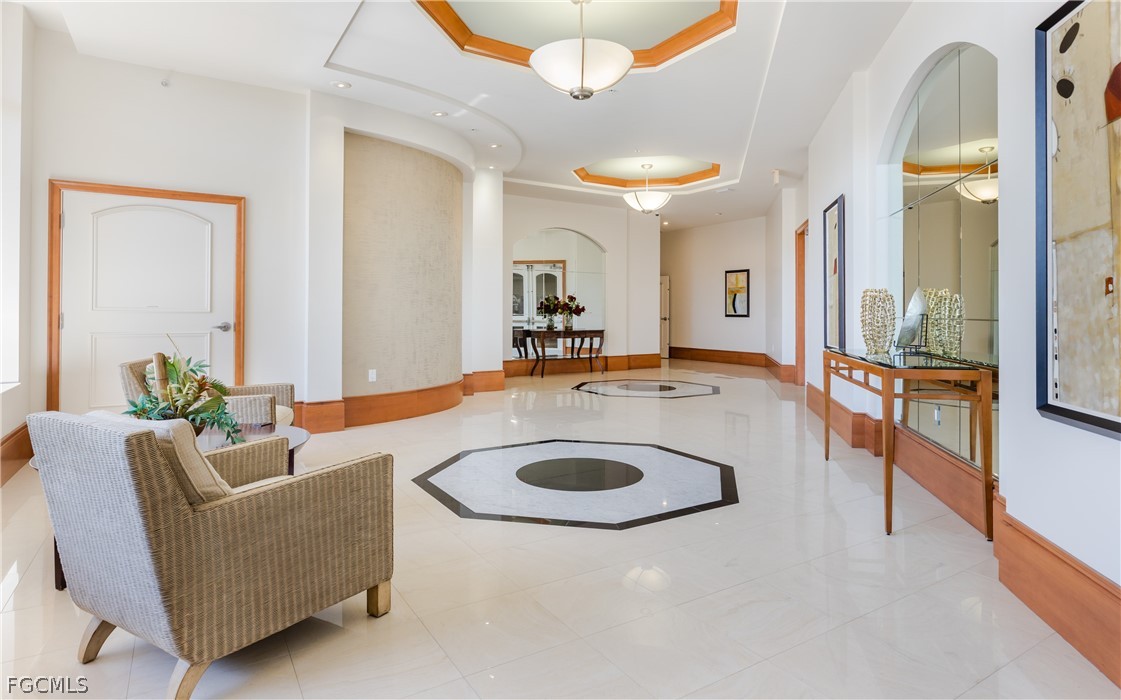 2090 West First Street, Unit J2510 Fort Myers, FL 33901 - Photo 41 of 50 a living room with furniture and a chandelier