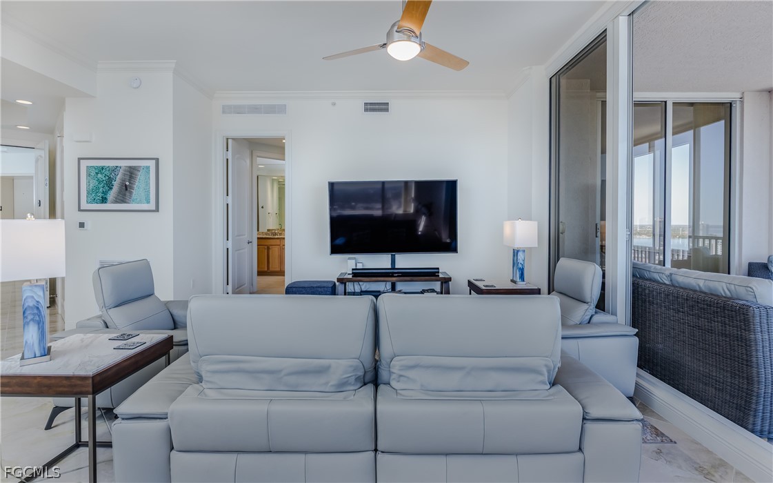 2090 West First Street, Unit J2510 Fort Myers, FL 33901 - Photo 7 of 50 a living room with furniture and a flat screen tv