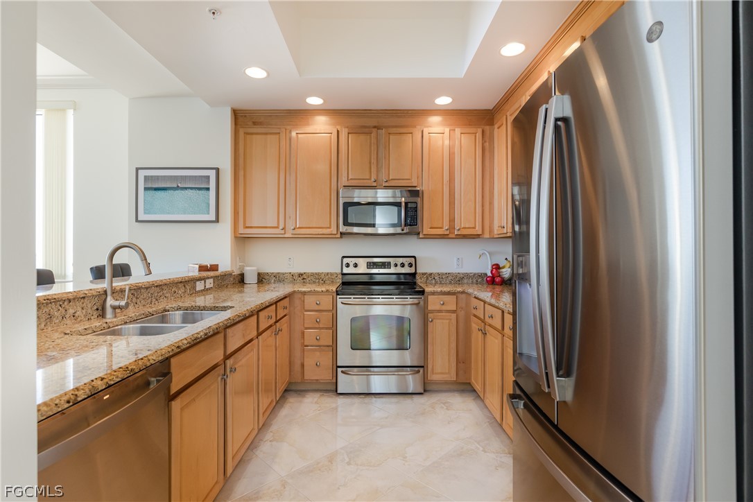 2090 West First Street, Unit J2510 Fort Myers, FL 33901 - Photo 10 of 50 a kitchen with stainless steel appliances granite countertop a refrigerator sink and stove