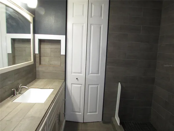 a white toilet sitting next to a bathroom sink