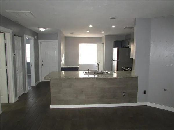 a view of room with window and wooden floor