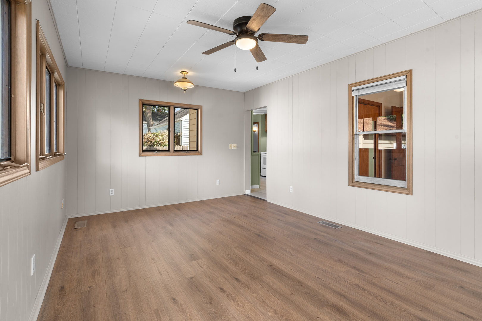 1149 Wilson Drive Kankakee, IL 60901 - Photo 11 of 23 a view of an empty room with a window and wooden floor