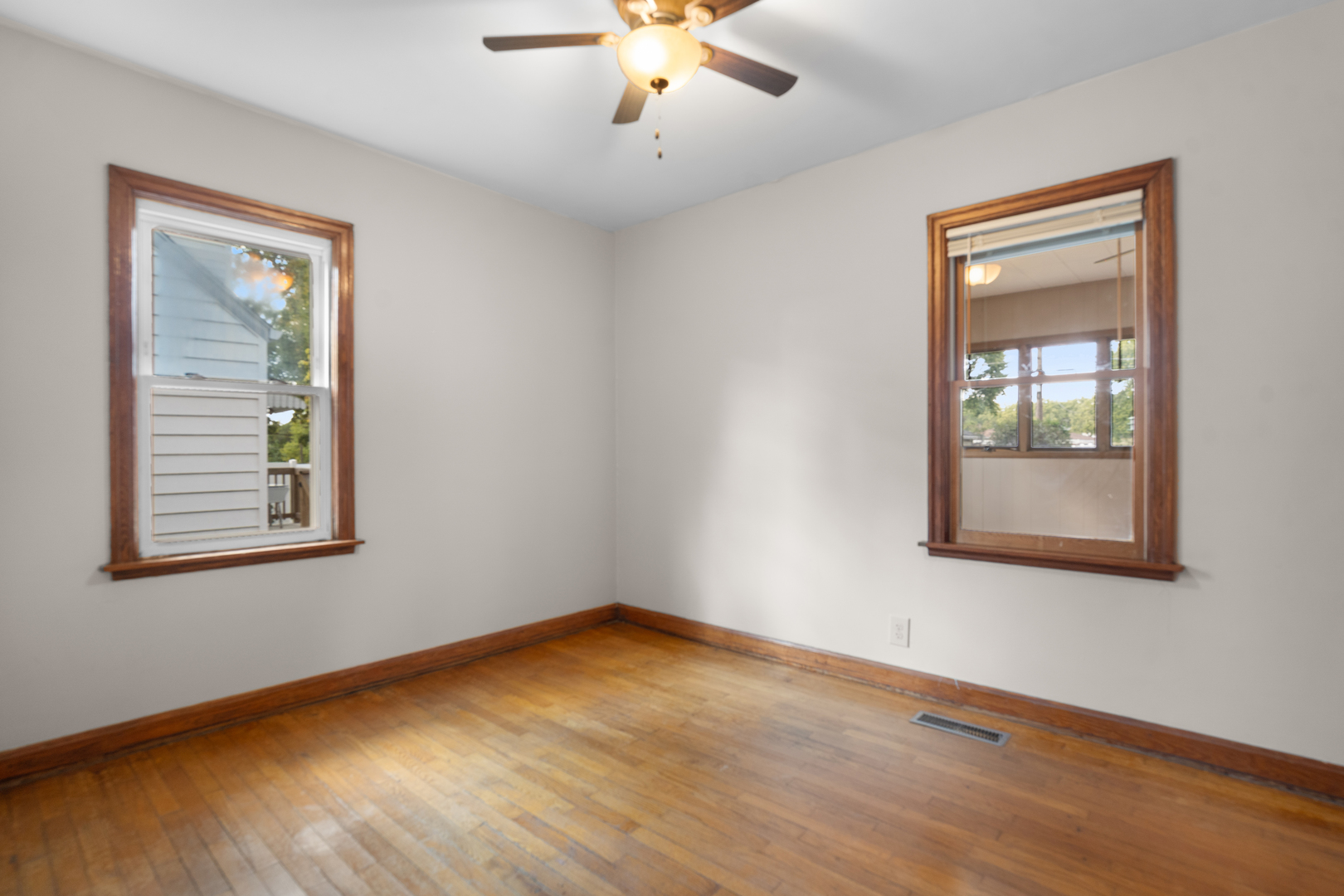 1149 Wilson Drive Kankakee, IL 60901 - Photo 14 of 23 a view of an empty room with wooden floor and a window