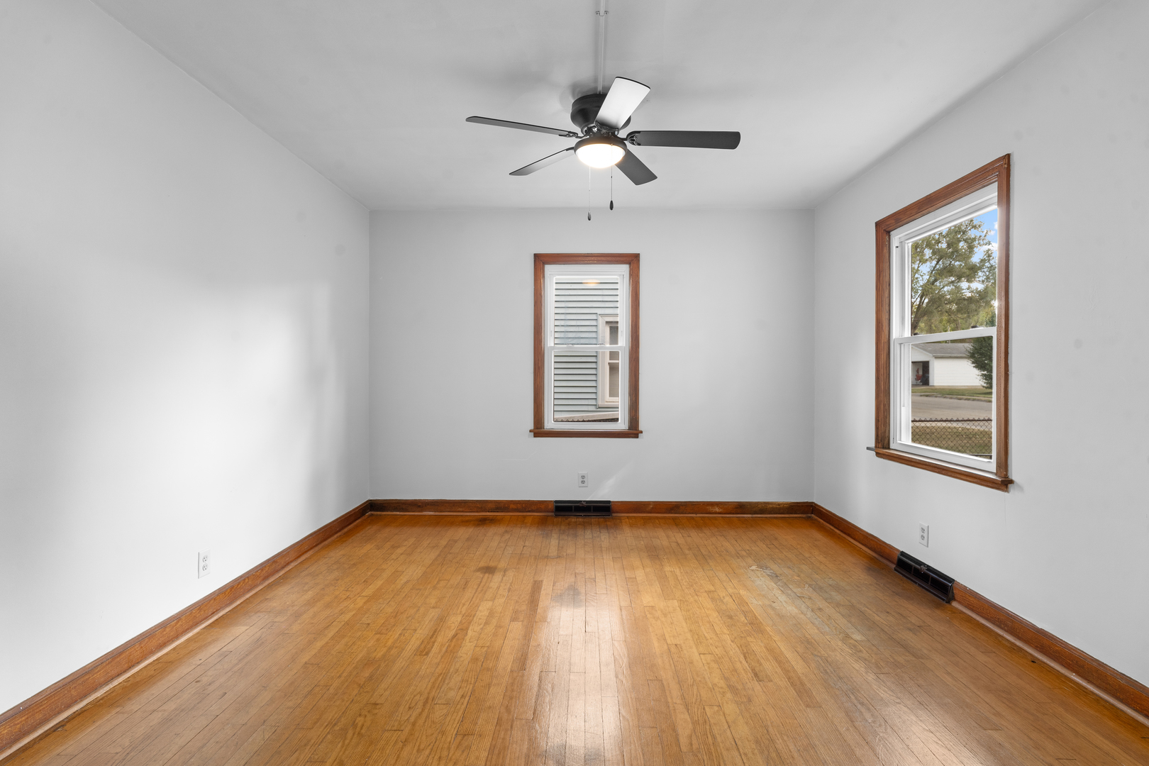 1149 Wilson Drive Kankakee, IL 60901 - Photo 4 of 23 a view of a room with wooden floors and ceiling fan