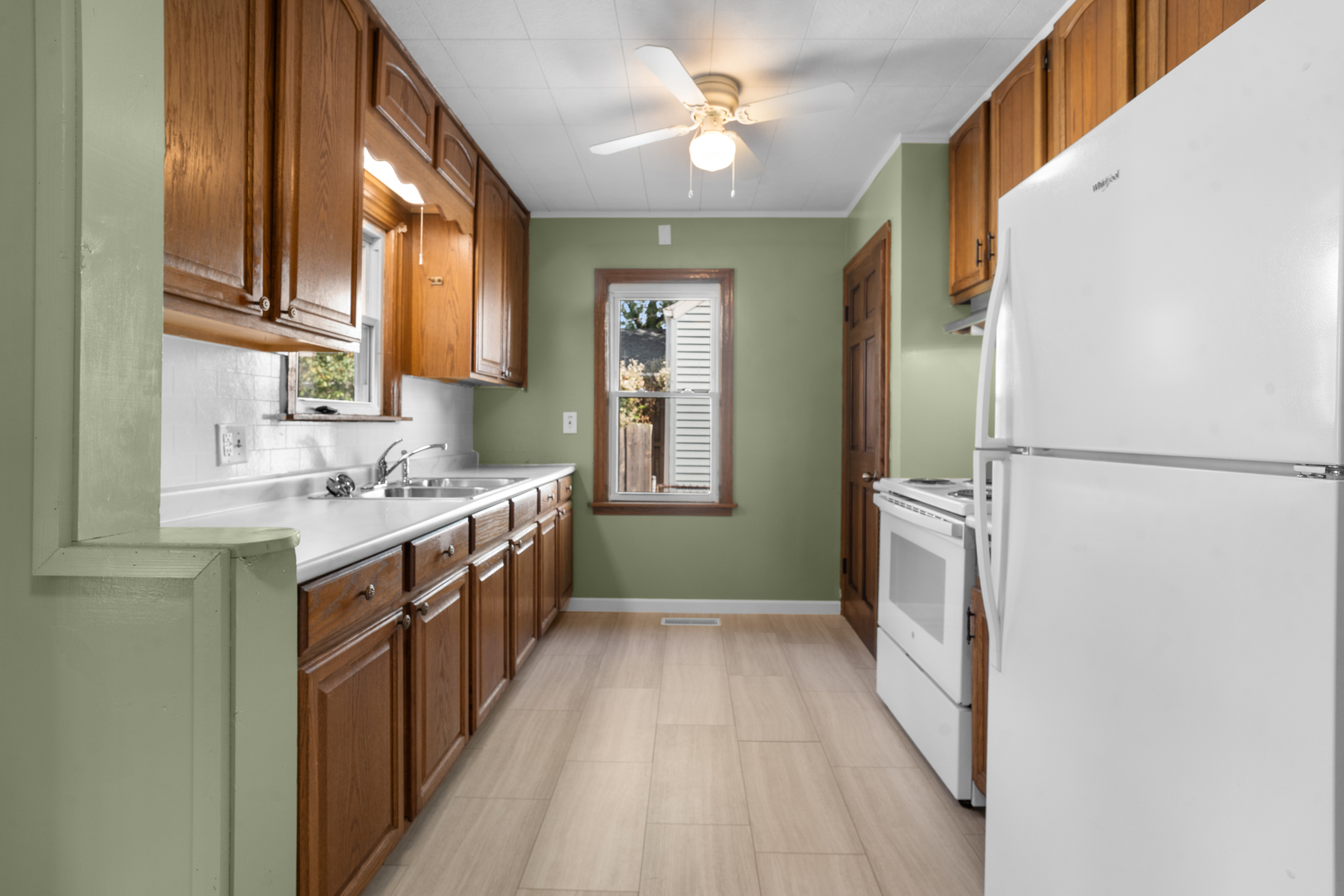 1149 Wilson Drive Kankakee, IL 60901 - Photo 7 of 23 a kitchen with a sink a refrigerator a washer and dryer