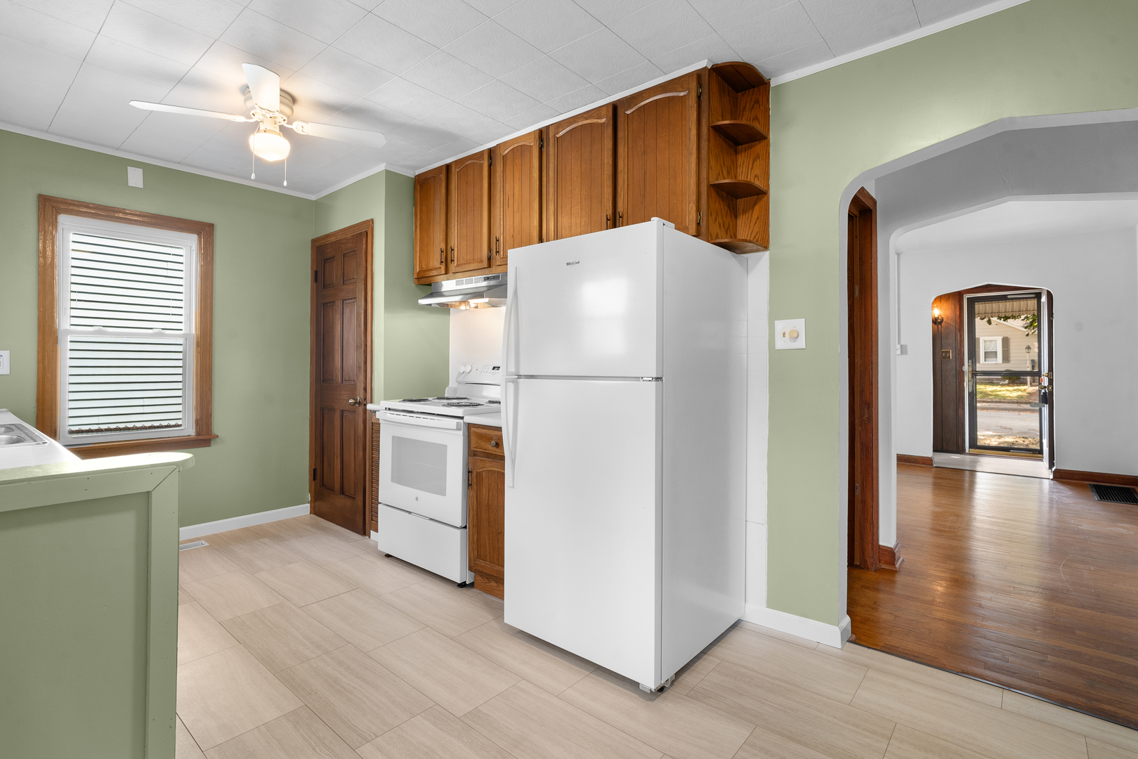 1149 Wilson Drive Kankakee, IL 60901 - Photo 8 of 23 a white refrigerator freezer and a stove sitting inside of a kitchen