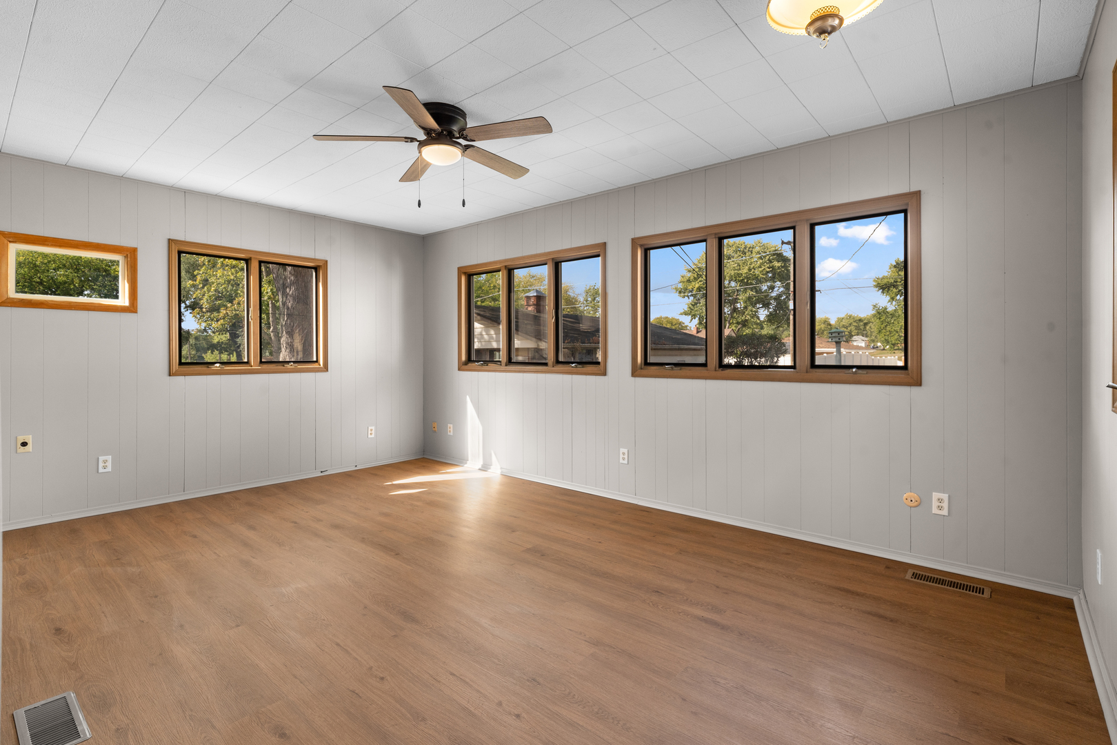 1149 Wilson Drive Kankakee, IL 60901 - Photo 10 of 23 a view of an empty room with a window and wooden floor