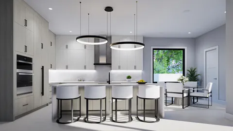 a kitchen with a dining table chairs and white cabinets