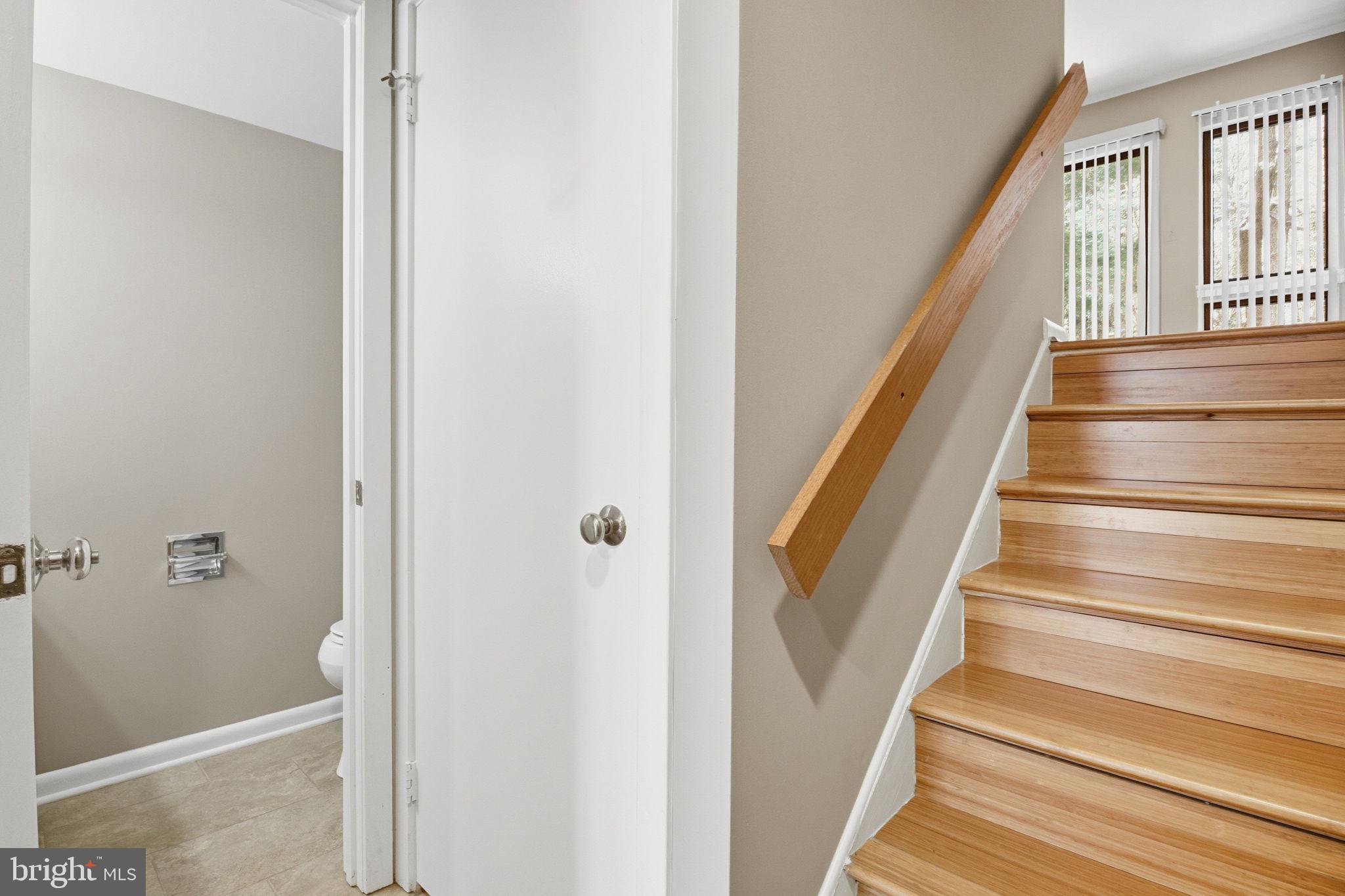 10995 Thrush Ridge Road Reston, VA 20191 - Photo 11 of 30 a view of staircase with wooden floor and a rug