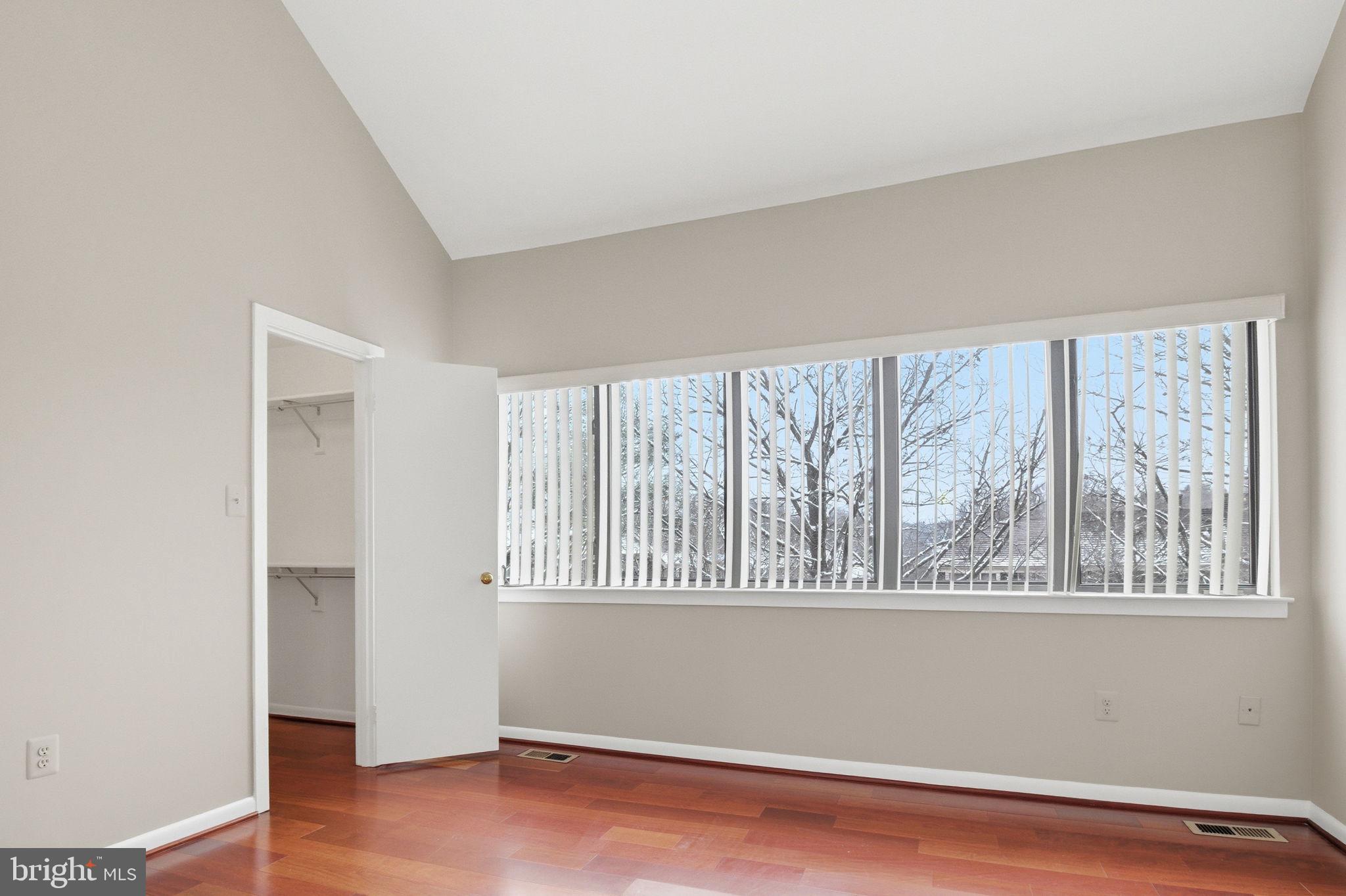 10995 Thrush Ridge Road Reston, VA 20191 - Photo 14 of 30 an empty room with wooden floor and windows