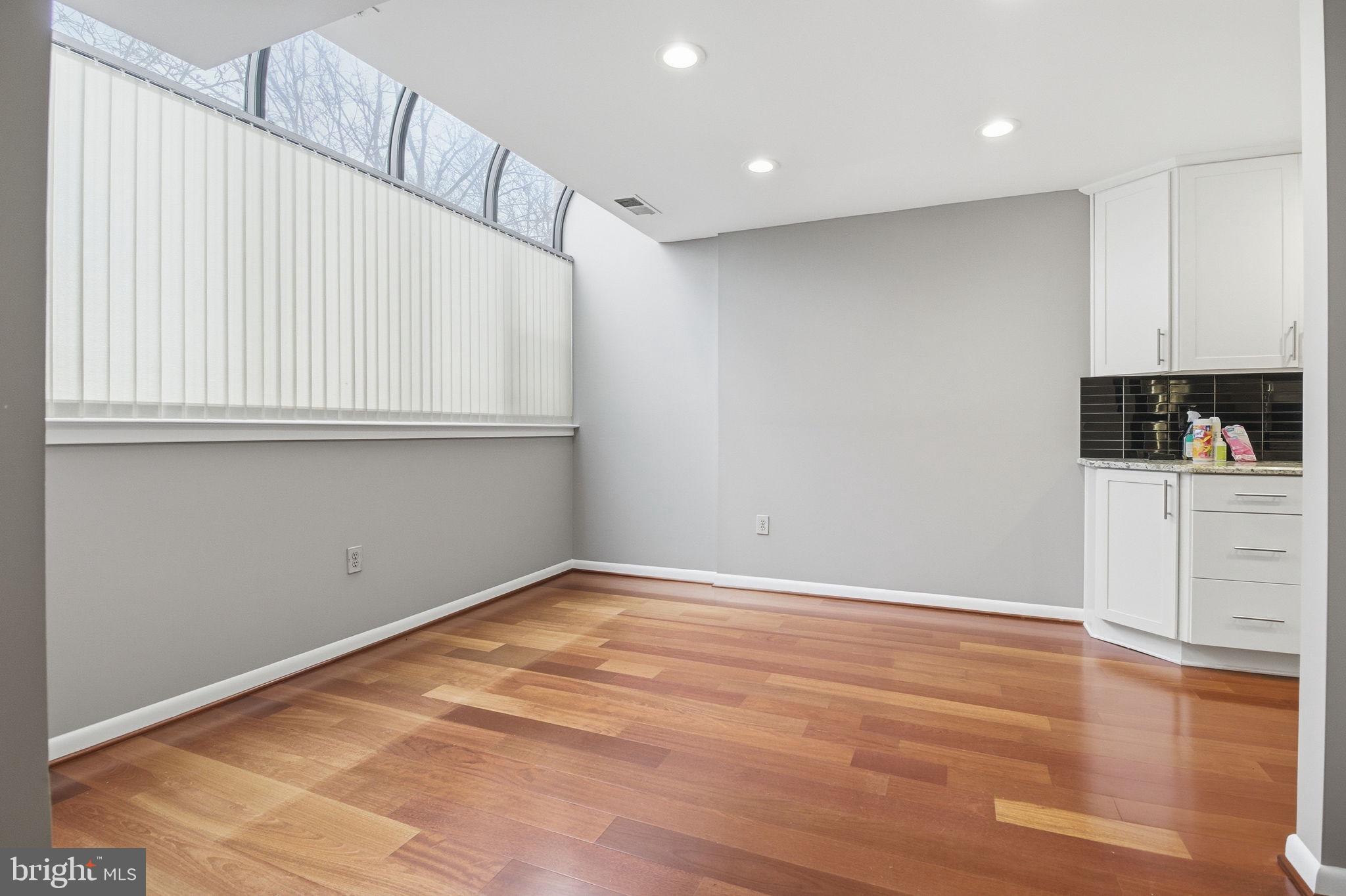 10995 Thrush Ridge Road Reston, VA 20191 - Photo 5 of 30 a view of a kitchen with white cabinets and wooden floor