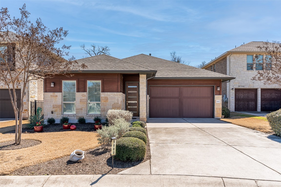 a front view of a house with a yard and glass windows