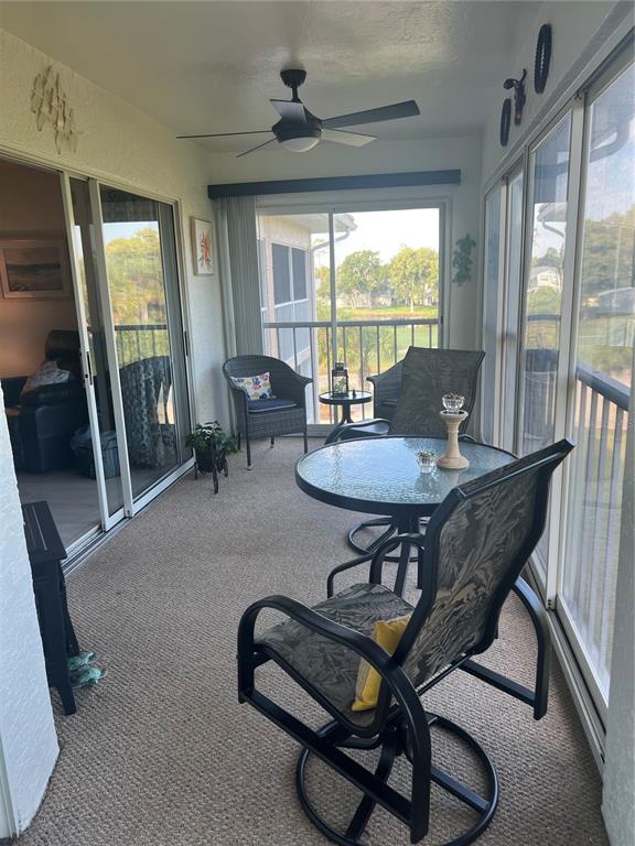 6501 Stone River Road, Unit 309 Bradenton, FL 34203 - Photo 13 of 33 a living room with furniture a flat screen tv and a large window
