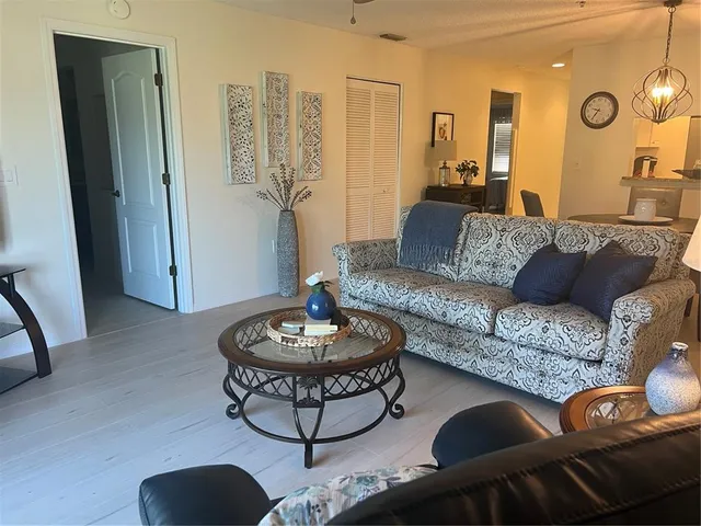 a living room with furniture and a large mirror